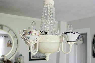 Attach the wiring to the ceiling outlet and hang the chandelier on a sturdy hook.