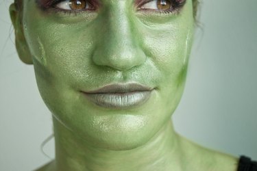 Blend black eye shadow underneath the cheekbones