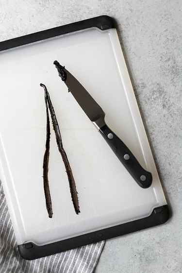 Vanilla bean and knife on a cutting board