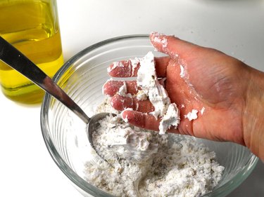 A hand compacting the mixture together.