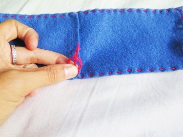 Knotting the thread on a DIY felt pencil case