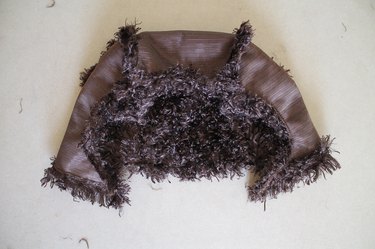 Hem the hood's edges.