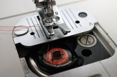 Pull both threads completely out.