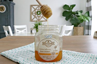 A jar of honey and honey dipper