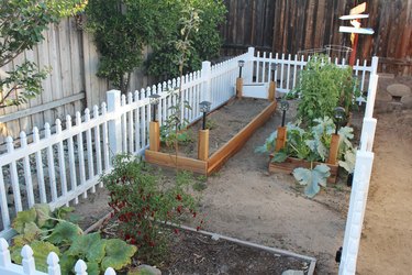 white fence surrounding a garden