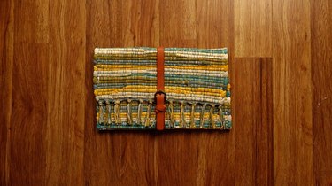 Upcycled no-sew clutch from a fabric placemat and faux leather belt