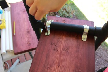 Attaching shelves to PVC pipe with galvanized hangers.