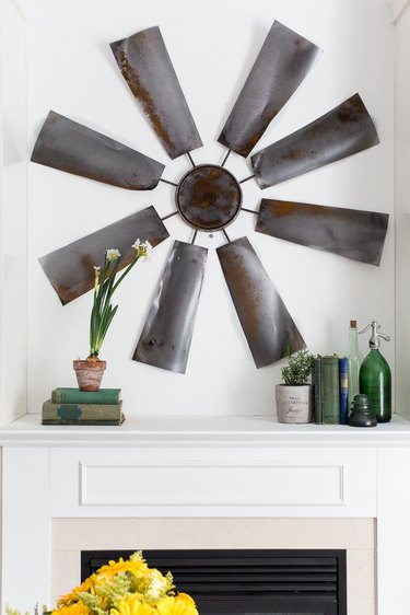 Completed windmill wall decor hanging above fireplace