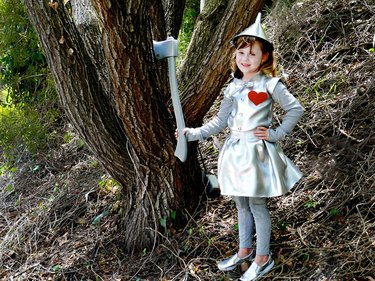 little girl dressed in tin man costume
