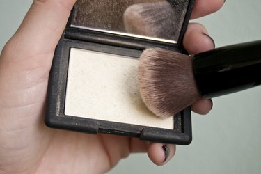 a makeup brush in highlighter
