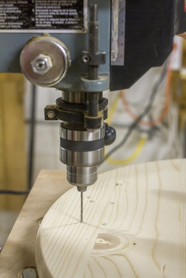 Pre-drill the marked holes where the casters will later be attached.
