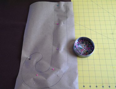 The template pinned to brown felt.