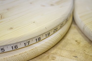 Mark three holes on each wood round where the braces will go.