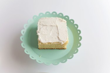 frosting on the first layer of cake