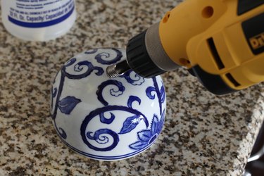 Drilling through the top of the lid at an angle