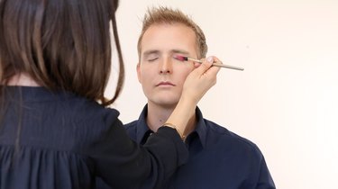 Apply red eyeshadow to upper lid