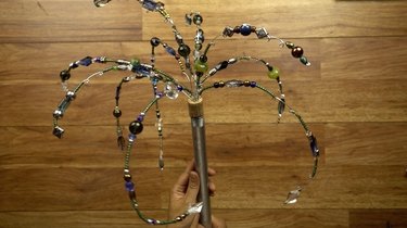 Inserting beaded wires into cork for DIY glass beaded garden sparkler.