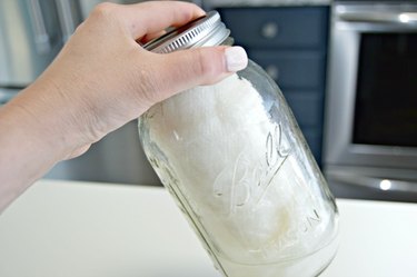 Mason jar with cleaning solution and paper towels