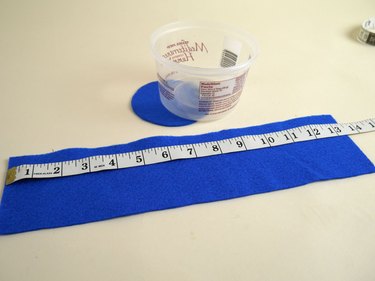 A plastic tub with a blue felt rectangle and circle matching the measurements of the tub.