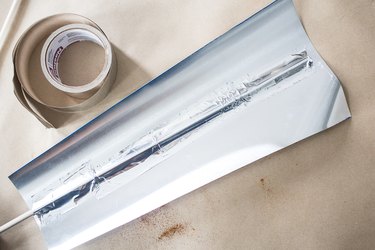 Adding duct tape over dowel