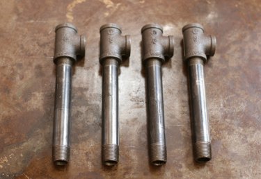 Four 6-inch pipes with fittings attached
