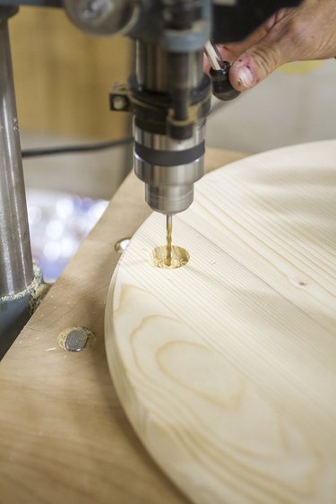 Pre-drill the centers of the already-drilled holes where the dowel rod braces will eventually be attached.