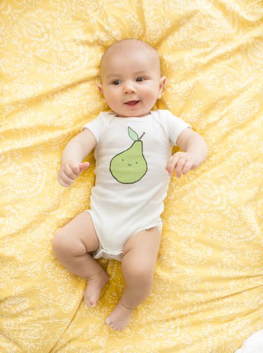 Baby with screen printed and painted bodysuit