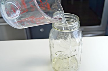 Adding vinegar to jar