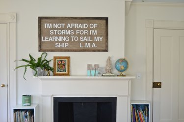 Stenciled artwork hanging over mantel
