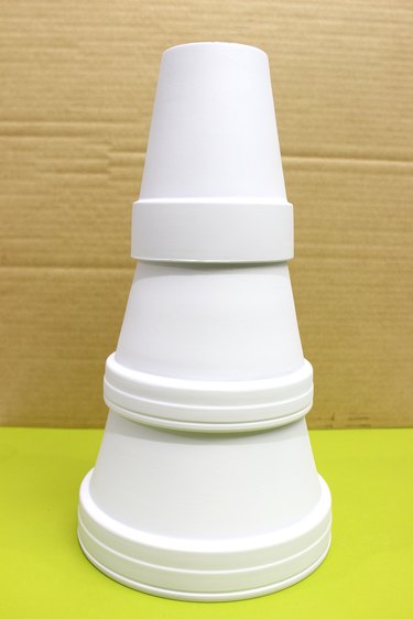 stack of clay pots painted white