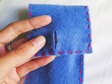 The cut slit in the flap of the DIY felt pencil case