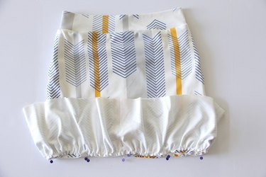 Attach the ruffle to the bottom of the pencil skirt