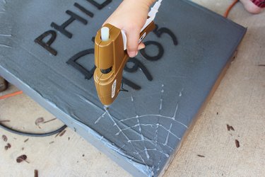 Creating a spider web using a hot glue gun