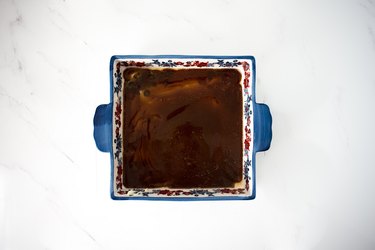 Melted butter and sugar in the base of a baking dish.