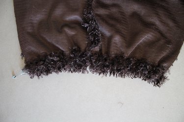 Secure the elastic by stitching it at each end of the hem.