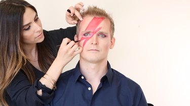 Lining lightning bolt with black liquid eyeliner