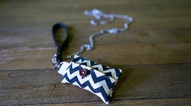 Back side of DIY dog waste bag dispenser and dog waste bag roll clipped to leash