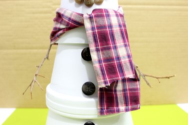 scarf tied around clay pot snowman