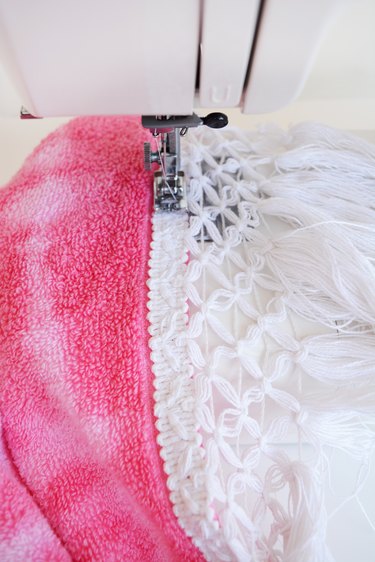 Sew the trim onto the towel.