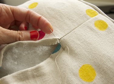 Pull needle up through the fold