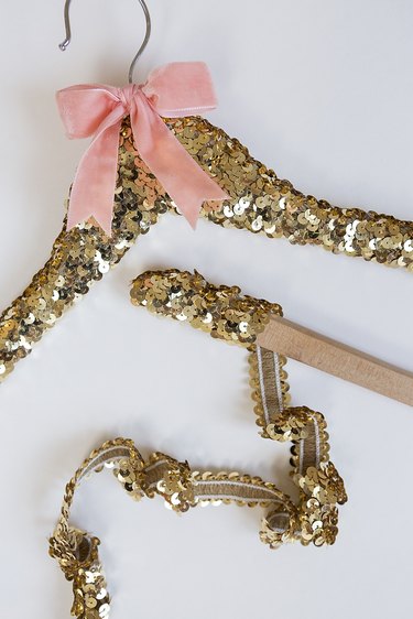 Sequin trim wrapping around hanger.
