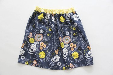 Sew an easy elastic waistband onto your gathered skirt