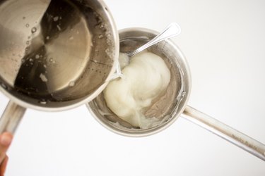 Pouring sugar syrup into saucepan with thickening paste.