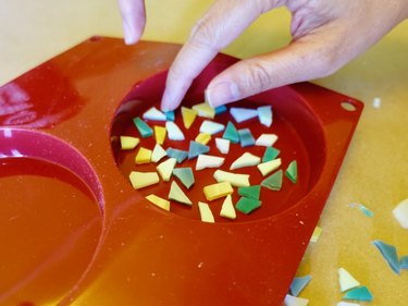 Arranging glass tile pieces on the bottom of silicone mold for DIY modern terrazzo coasters