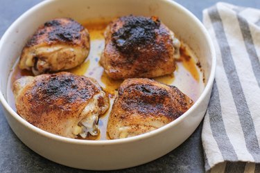 Four chicken thighs in a casserole dish