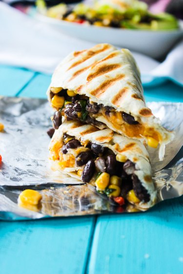 Grilled burritos on foil.