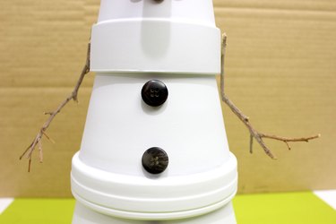 twig arms glued to top clay pot