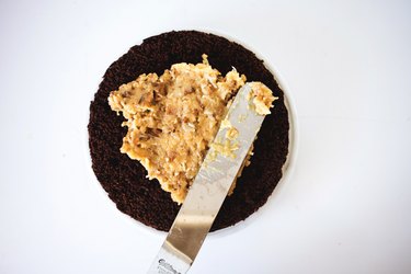 Spreading the filling on a cake layer.
