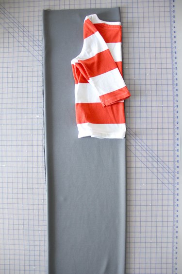 Lay you T-shirt flat along the fold of the fabric