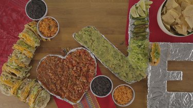 V filled with guacamole, lettuce and chiles.